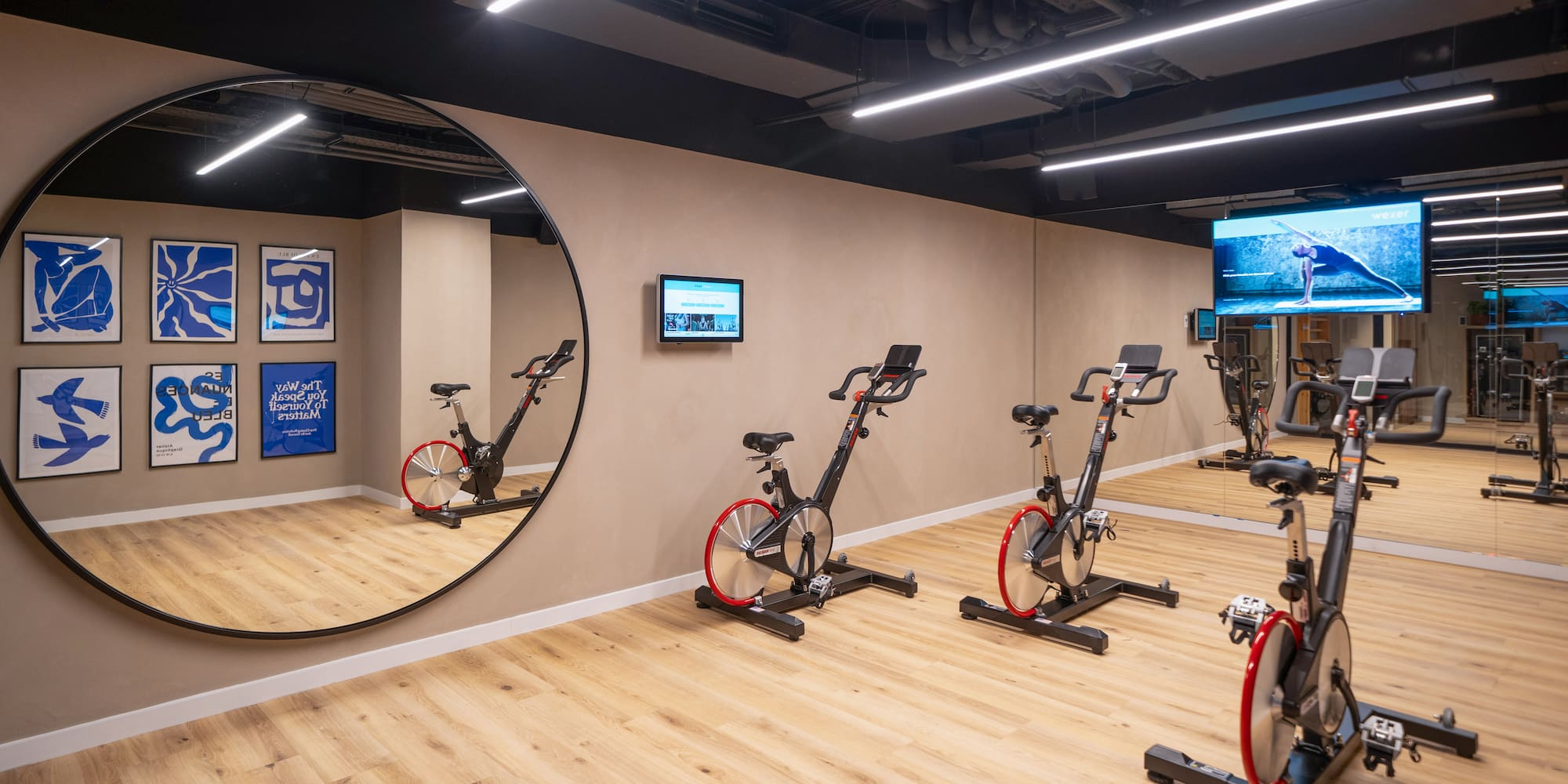 a room with exercise bikes and a mirror