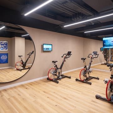 a room with exercise bikes and a mirror