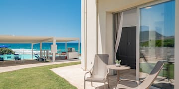 a patio with chairs and a table on the side of it