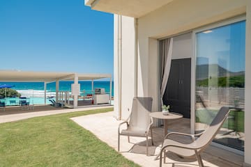 a patio with chairs and a table on the side of it