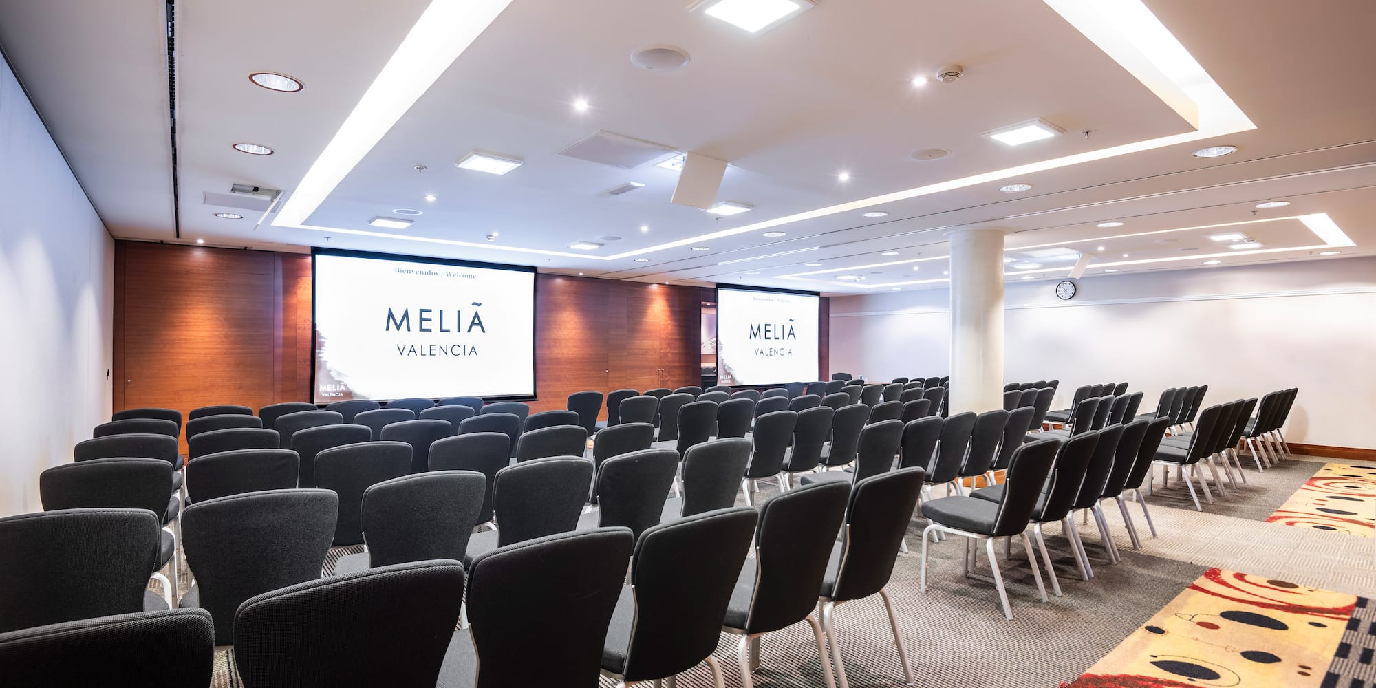 a room with chairs and a projector screen