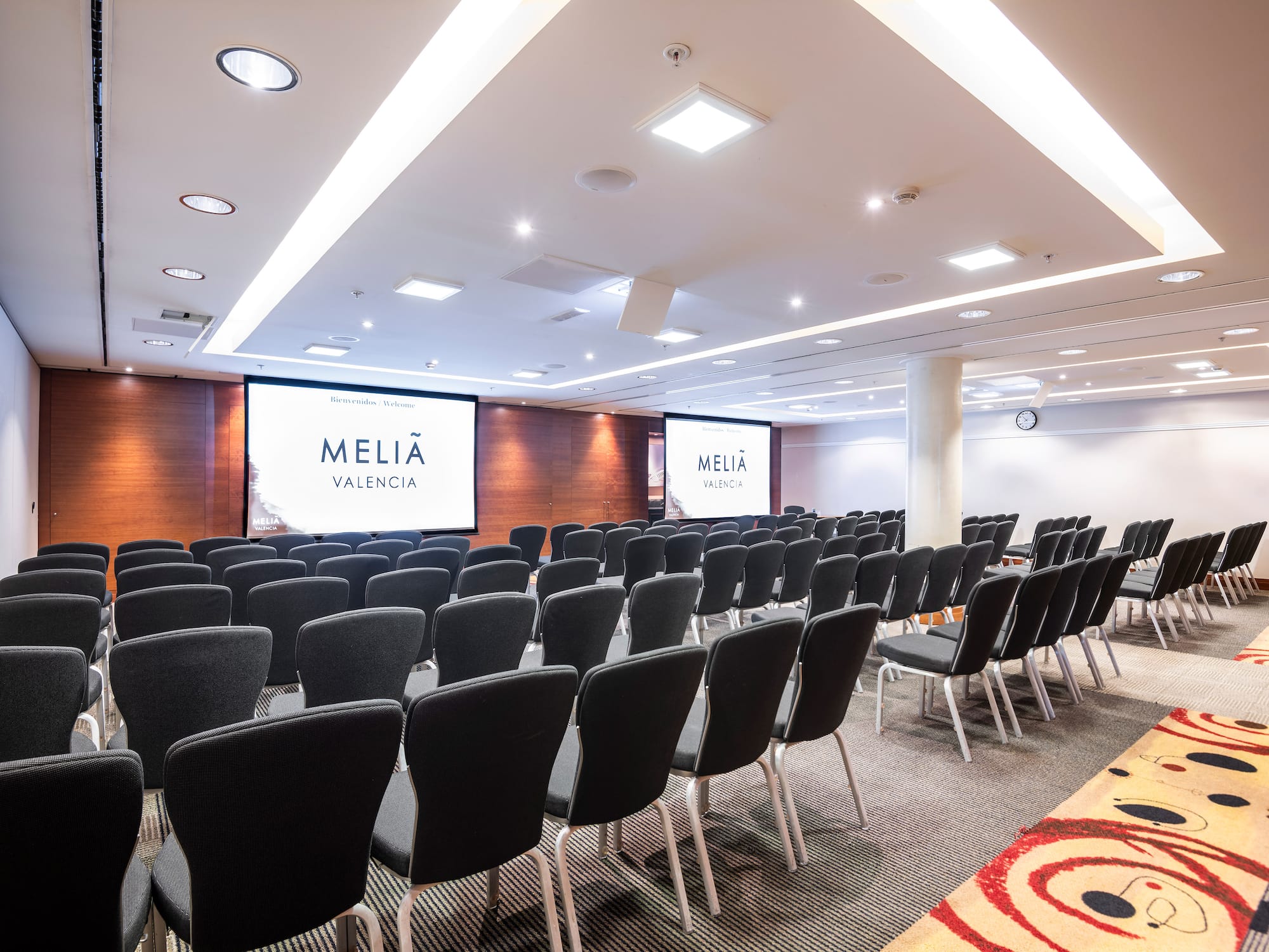 a room with chairs and a projector screen