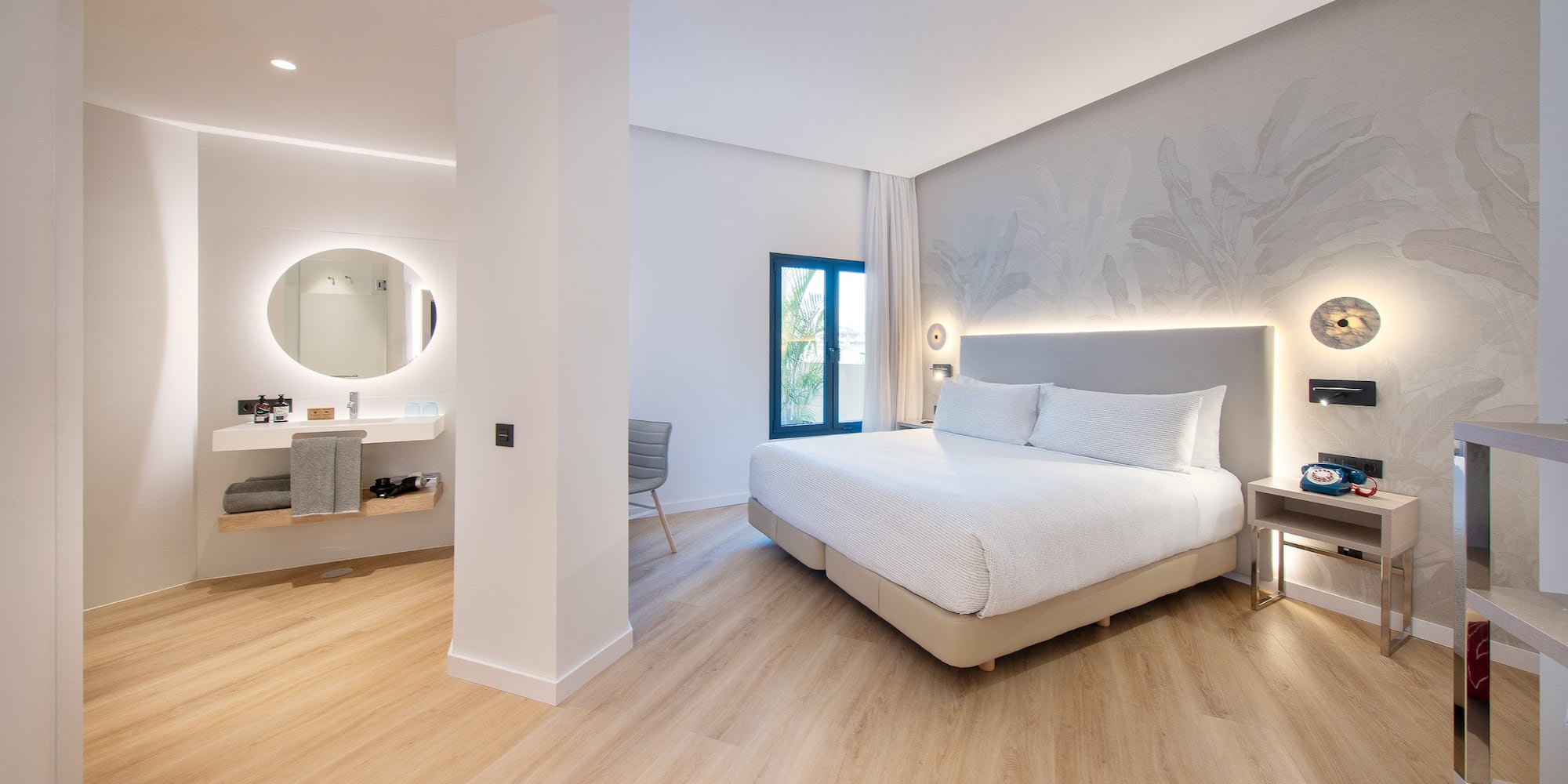 a bedroom with a large bed and a mirror