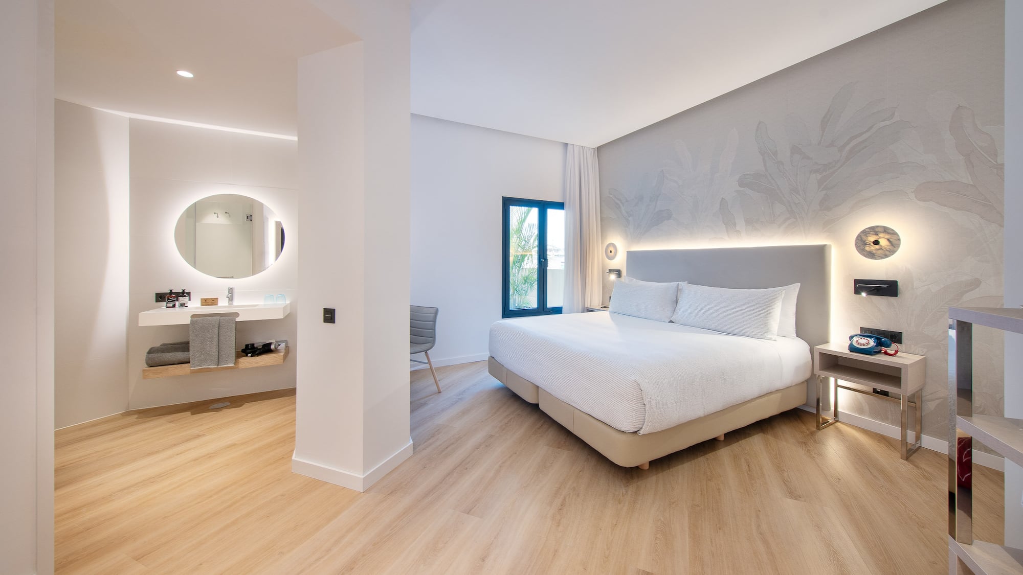 a bedroom with a large bed and a mirror