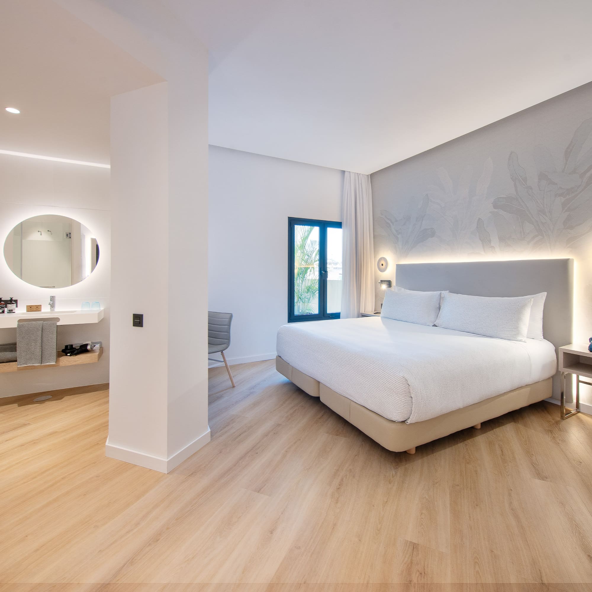 a bedroom with a large bed and a mirror