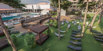 a resort with a pool and lounge chairs