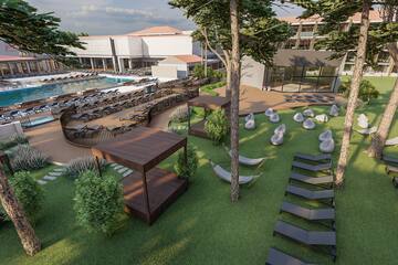 a resort with a pool and lounge chairs