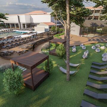 a resort with a pool and lounge chairs