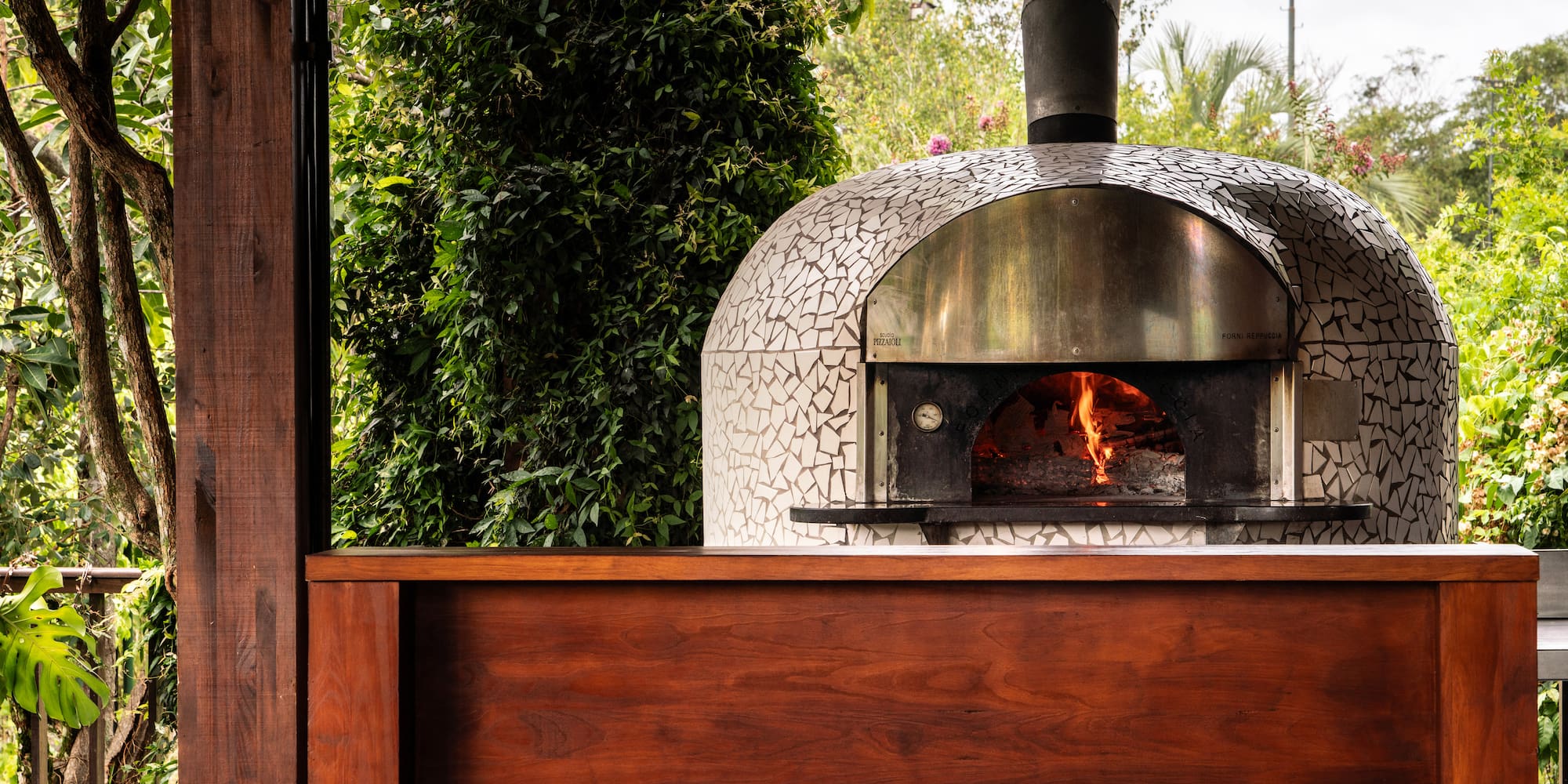 a wood burning oven with a wood wall