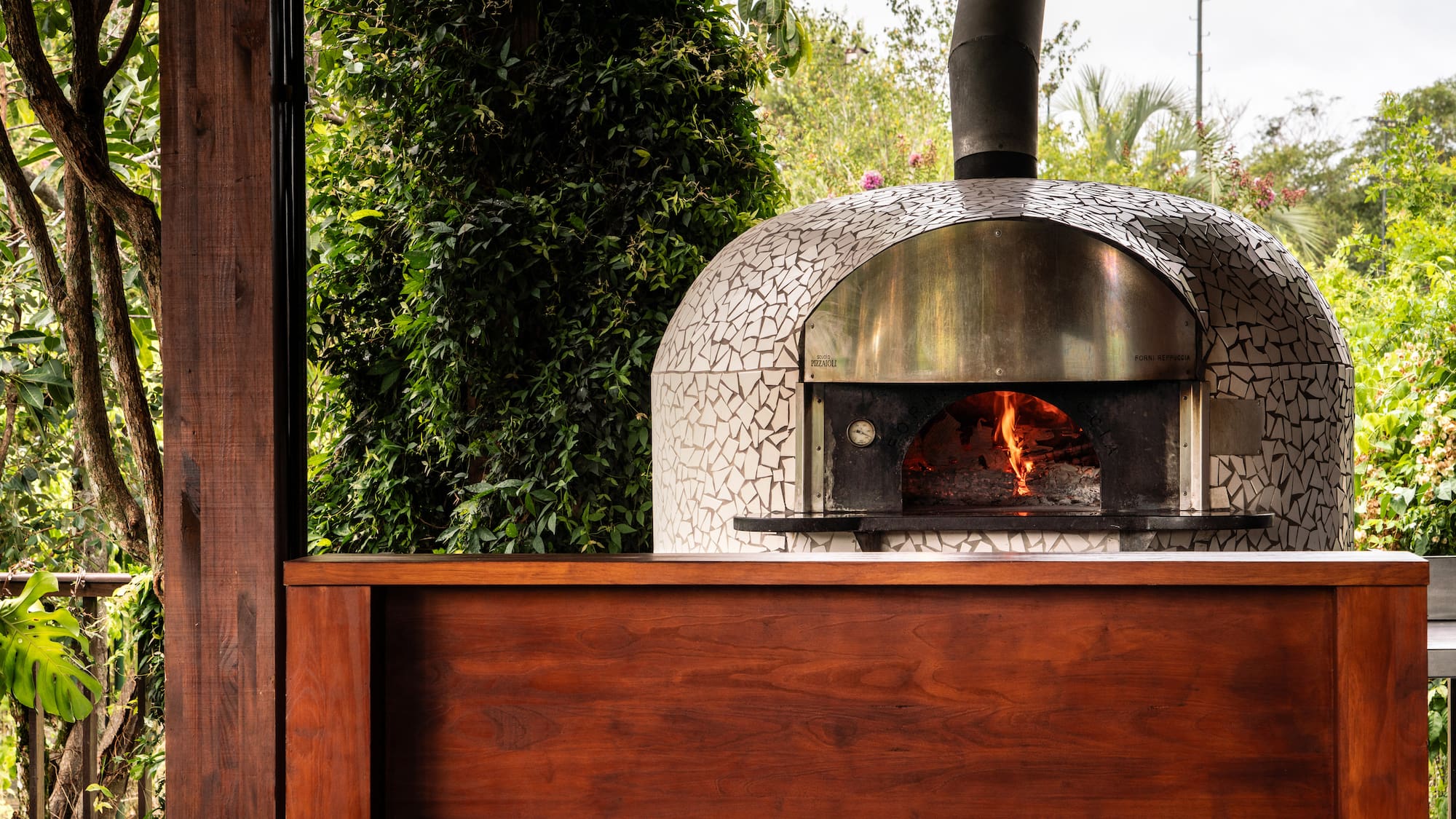 a wood burning oven with a wood wall