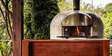 a wood burning oven with a wood wall