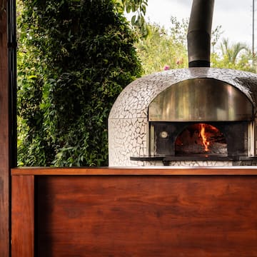 a wood burning oven with a wood wall