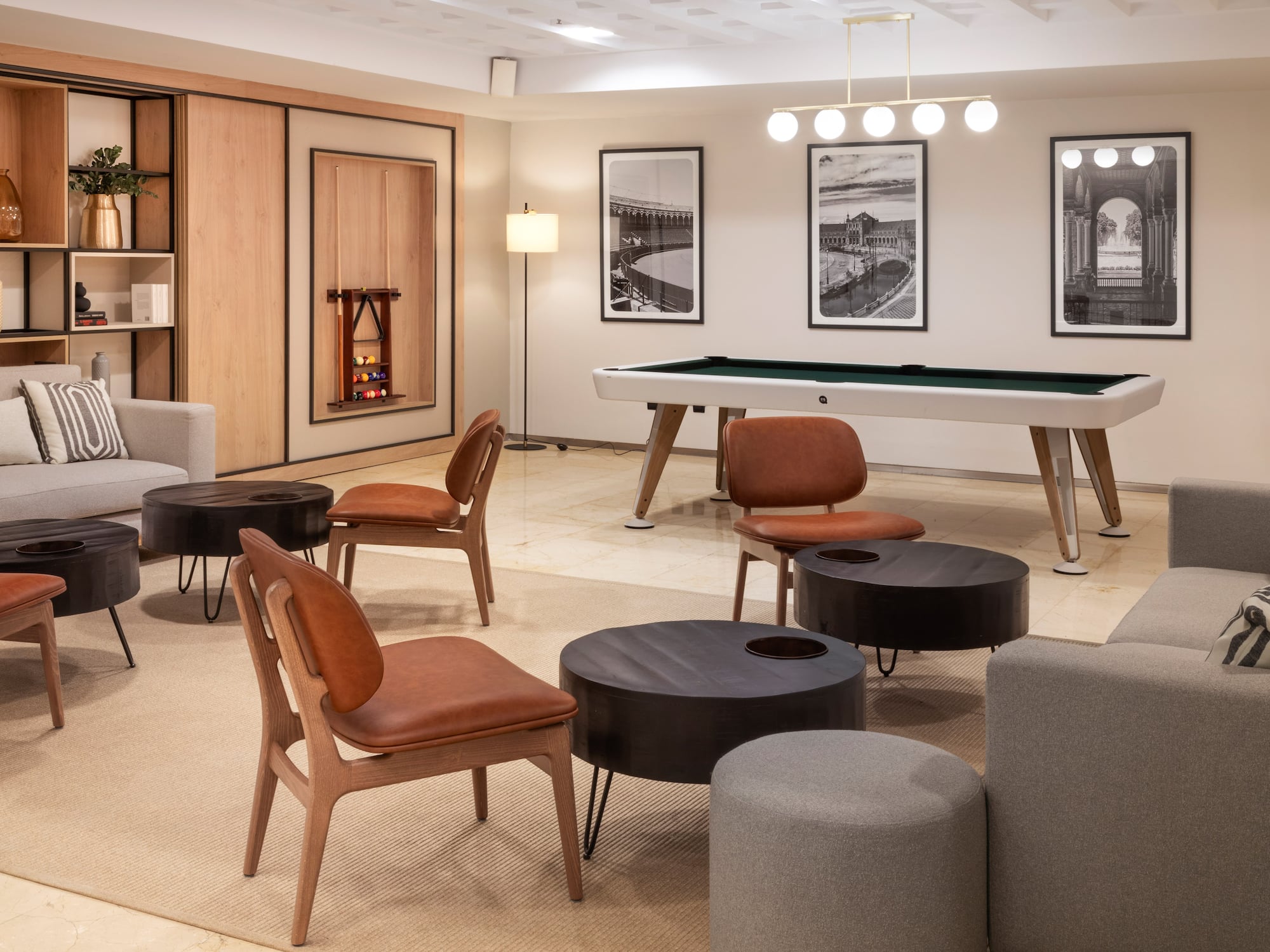 a room with a pool table and chairs