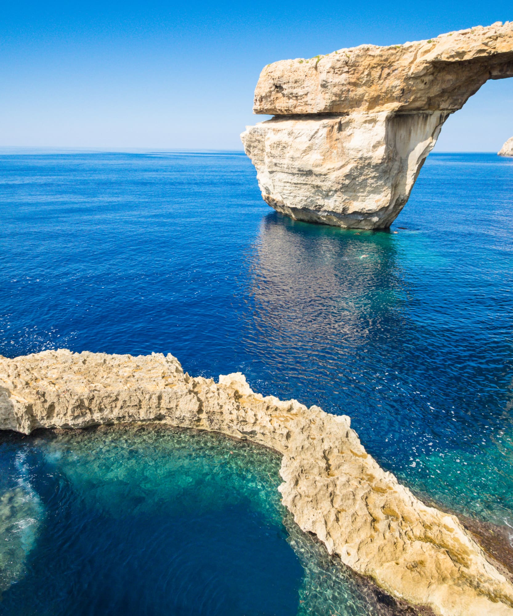 Azure Window natural rock arch over vibrant blue Mediterranean Sea, Gozo.