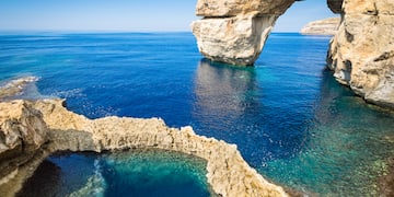 a rock arch over water