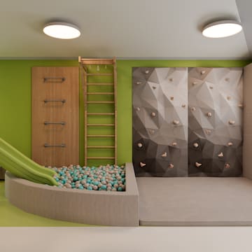 a room with a slide and a rock wall