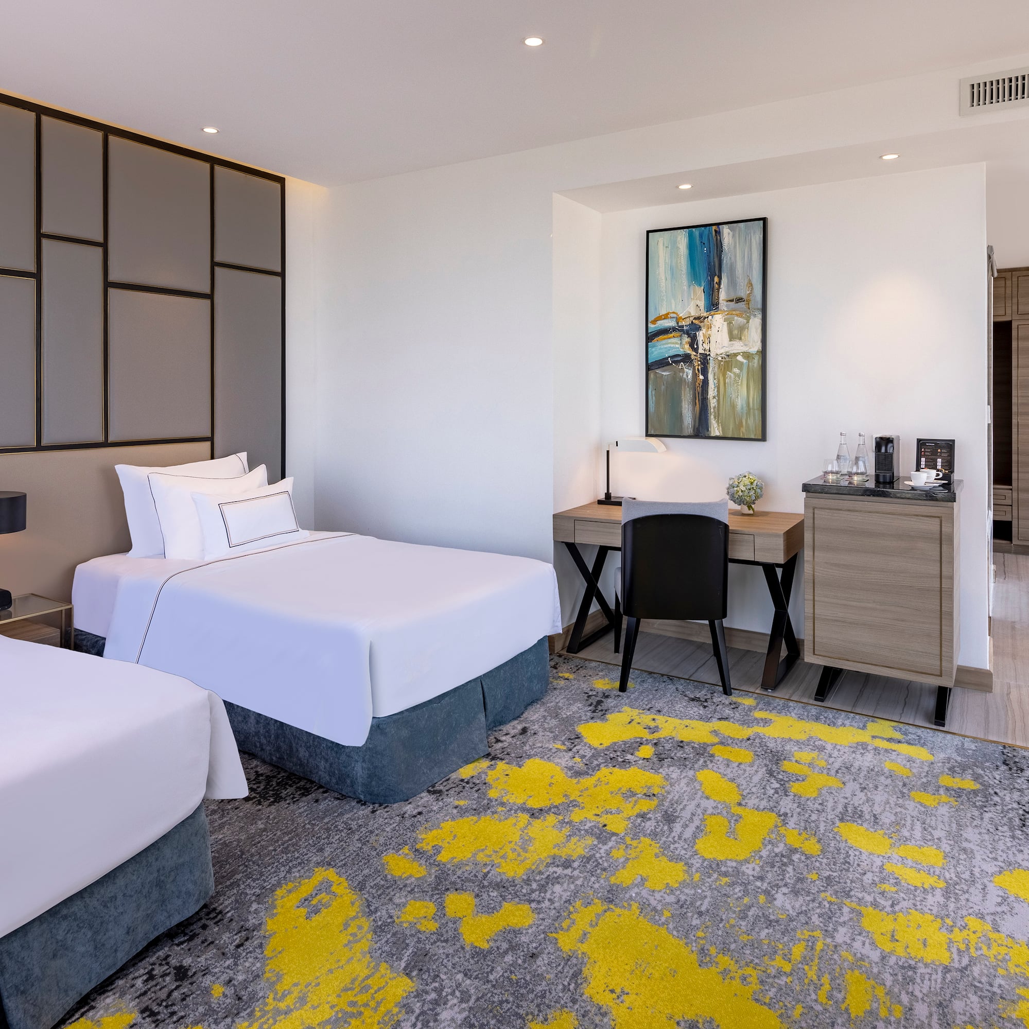 a room with two beds and a desk