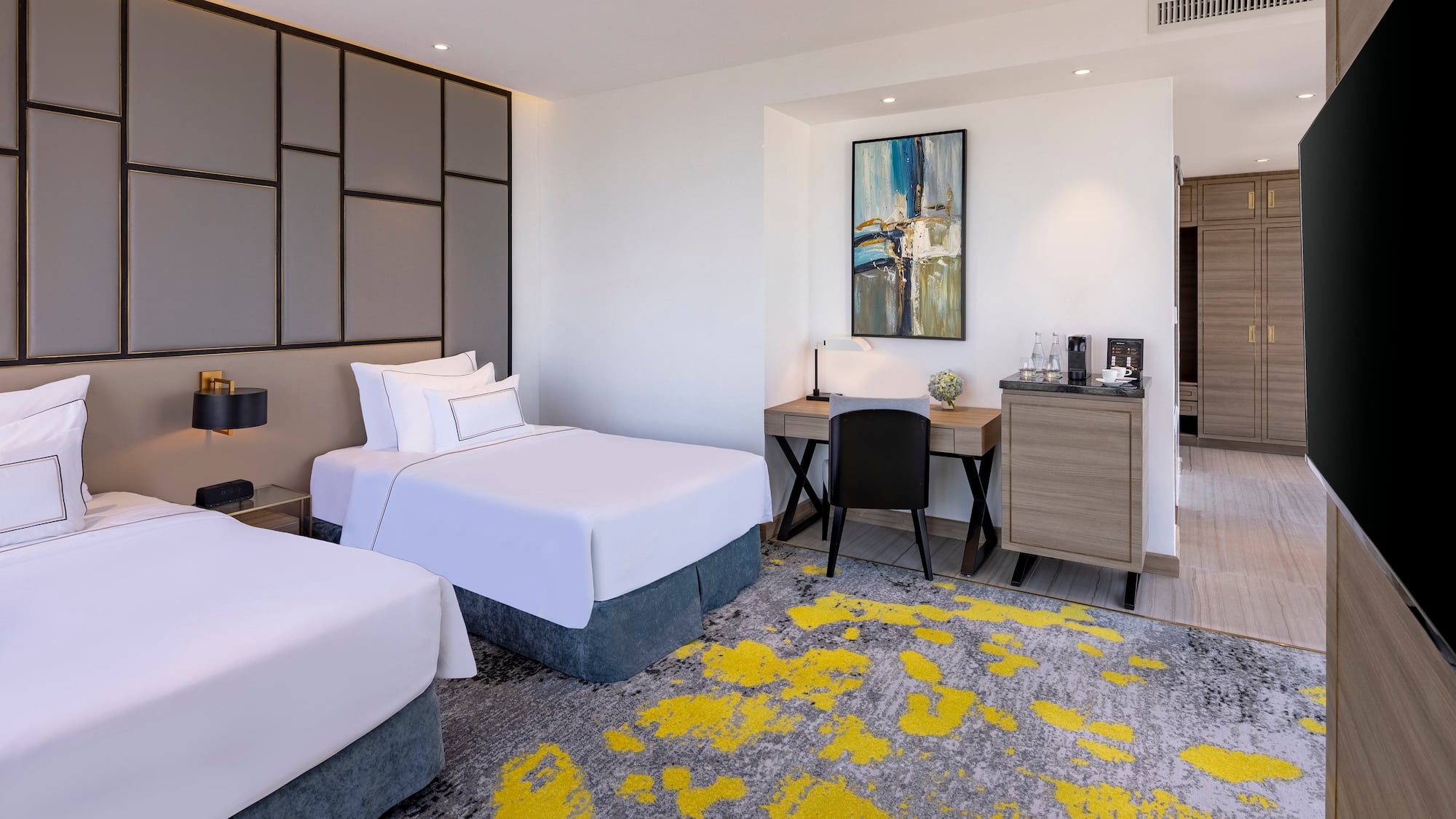 a room with two beds and a desk