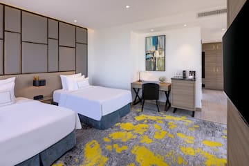 a room with two beds and a desk