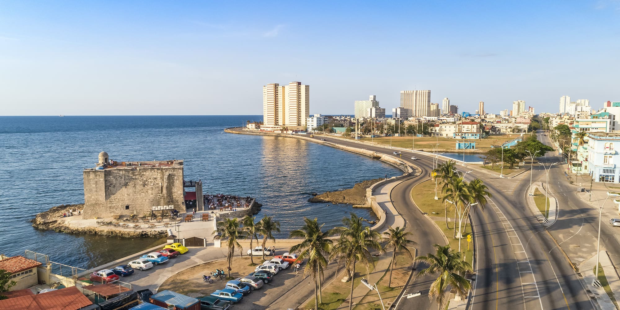 a road next to a body of water