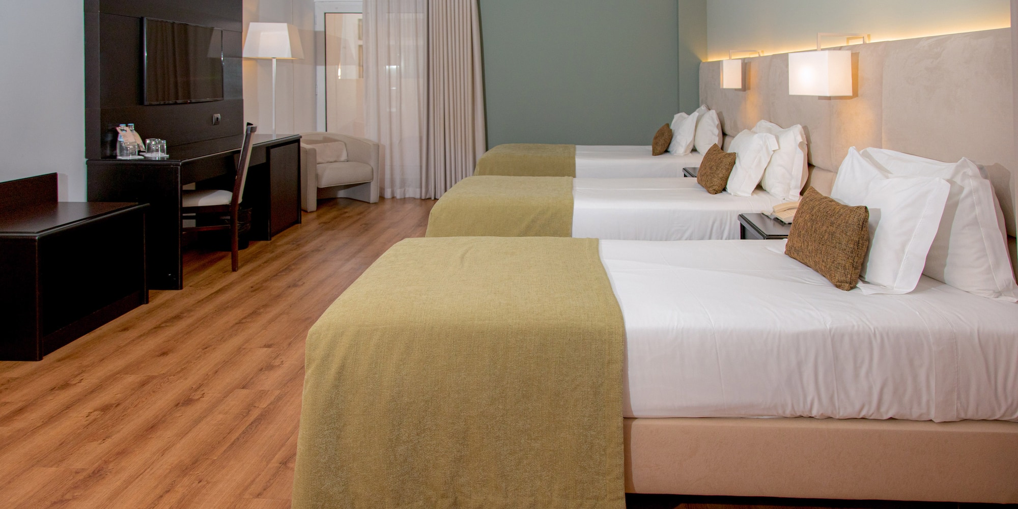 a room with beds and a tv