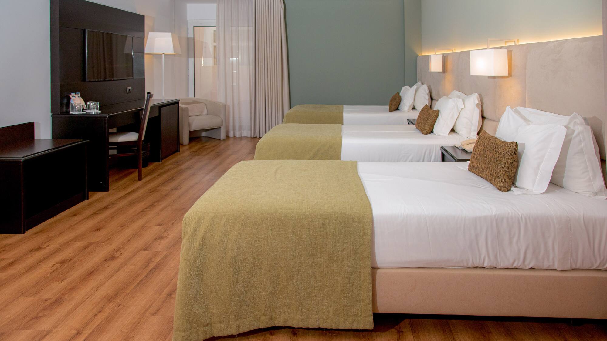 a room with beds and a tv