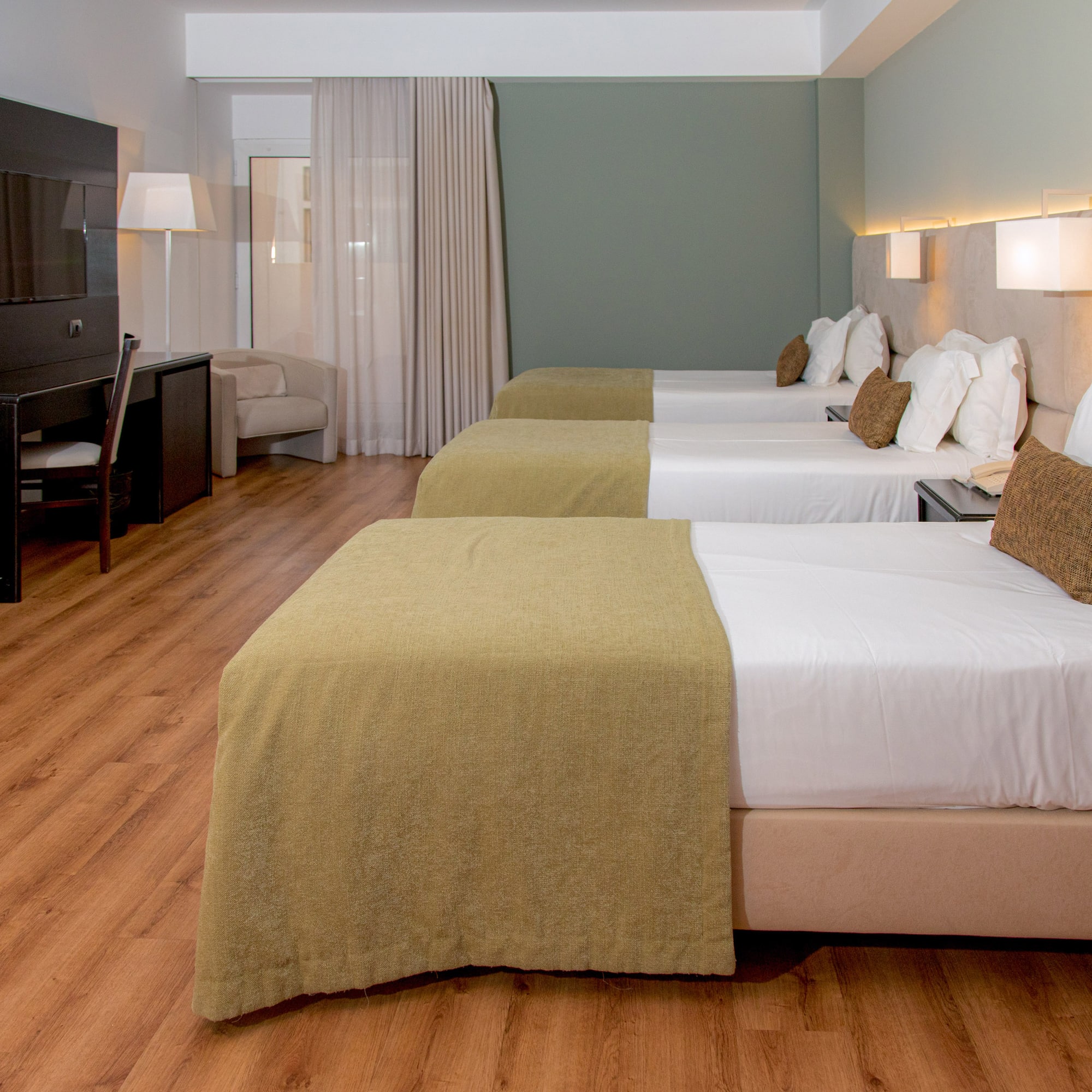 a room with beds and a tv