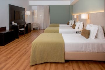 a room with beds and a tv