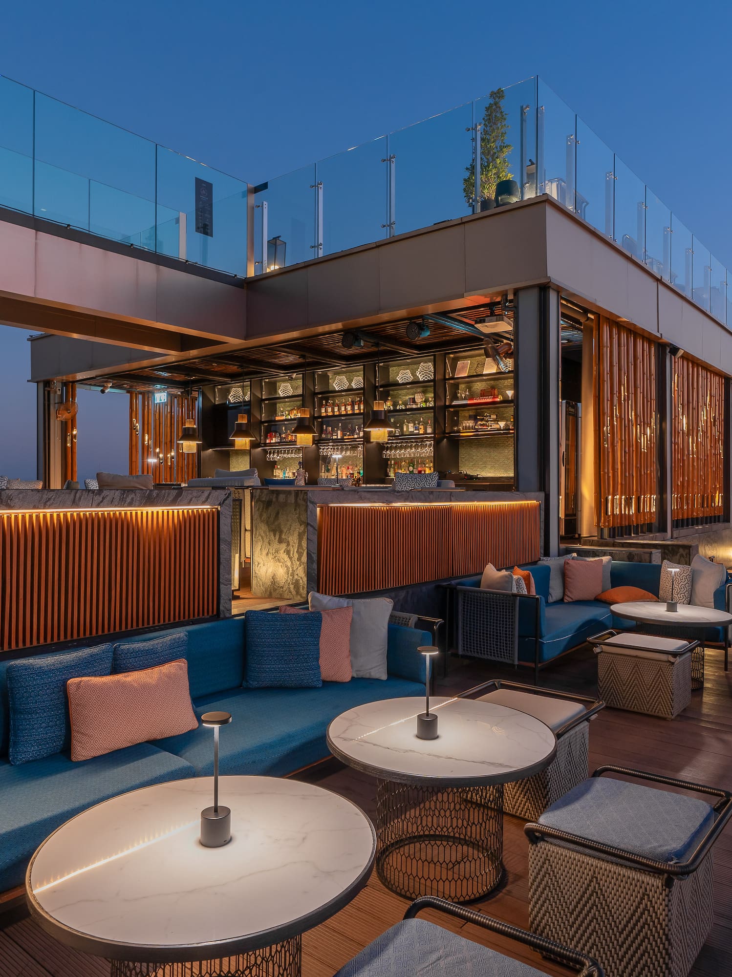 a rooftop bar with tables and chairs