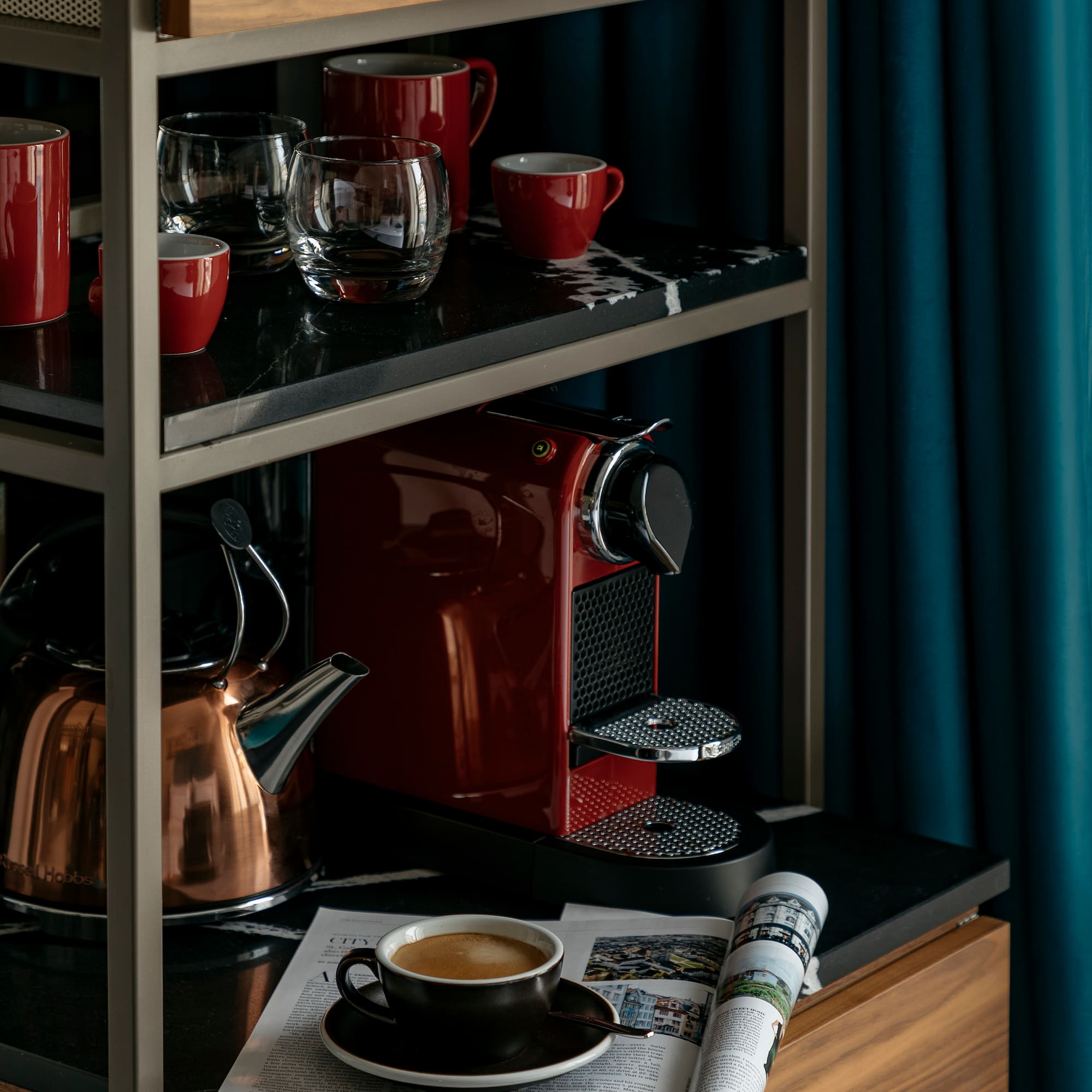 a coffee maker and cups on a shelf