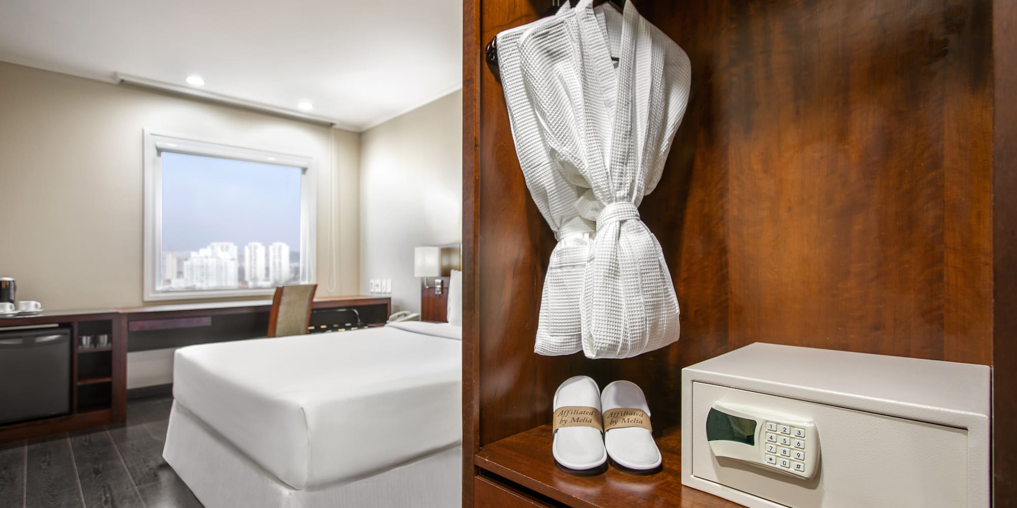 a white robe and slippers on a shelf in a hotel room