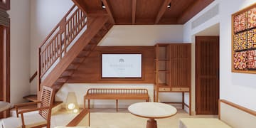 a room with a staircase and a tv