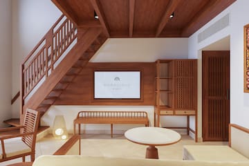 a room with a staircase and a tv