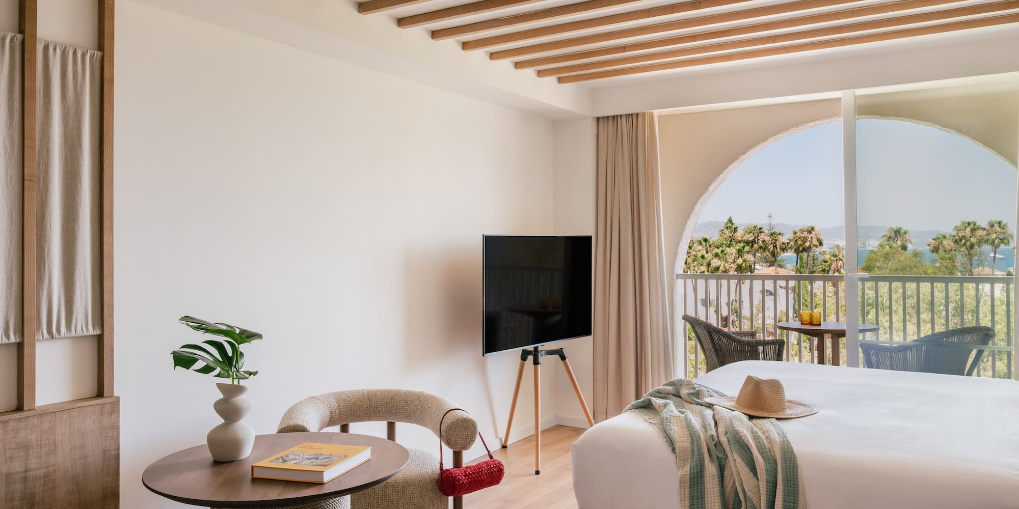 a room with a bed and a television