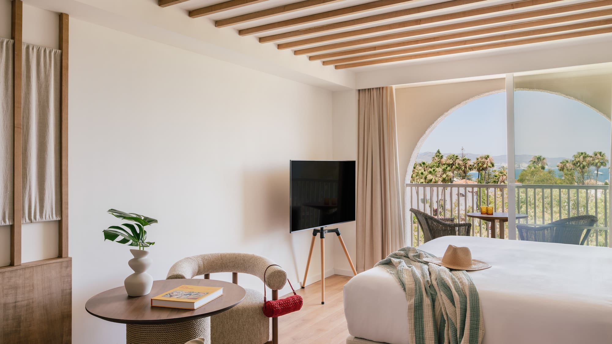 a room with a bed and a television