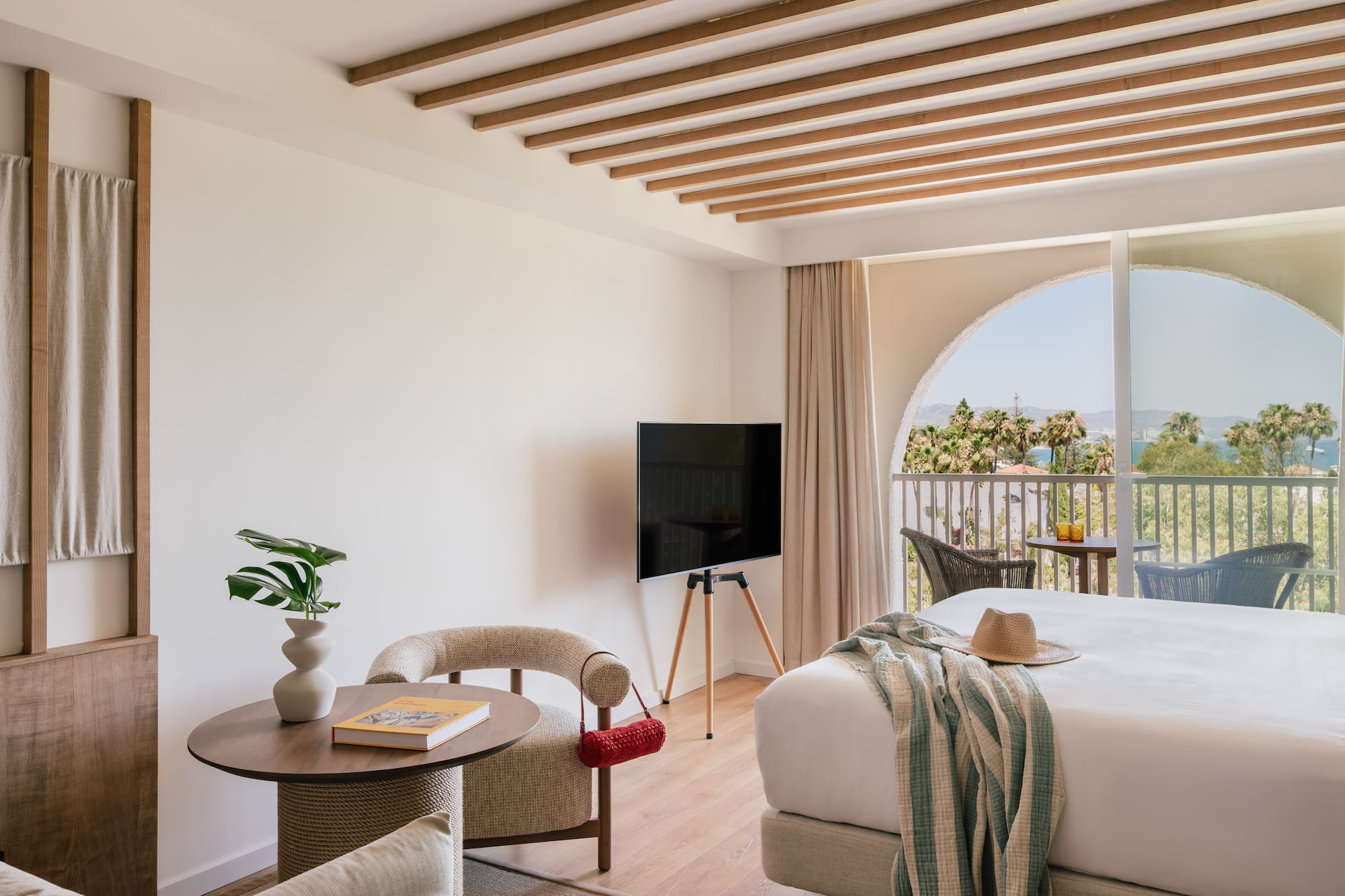 a room with a bed and a television