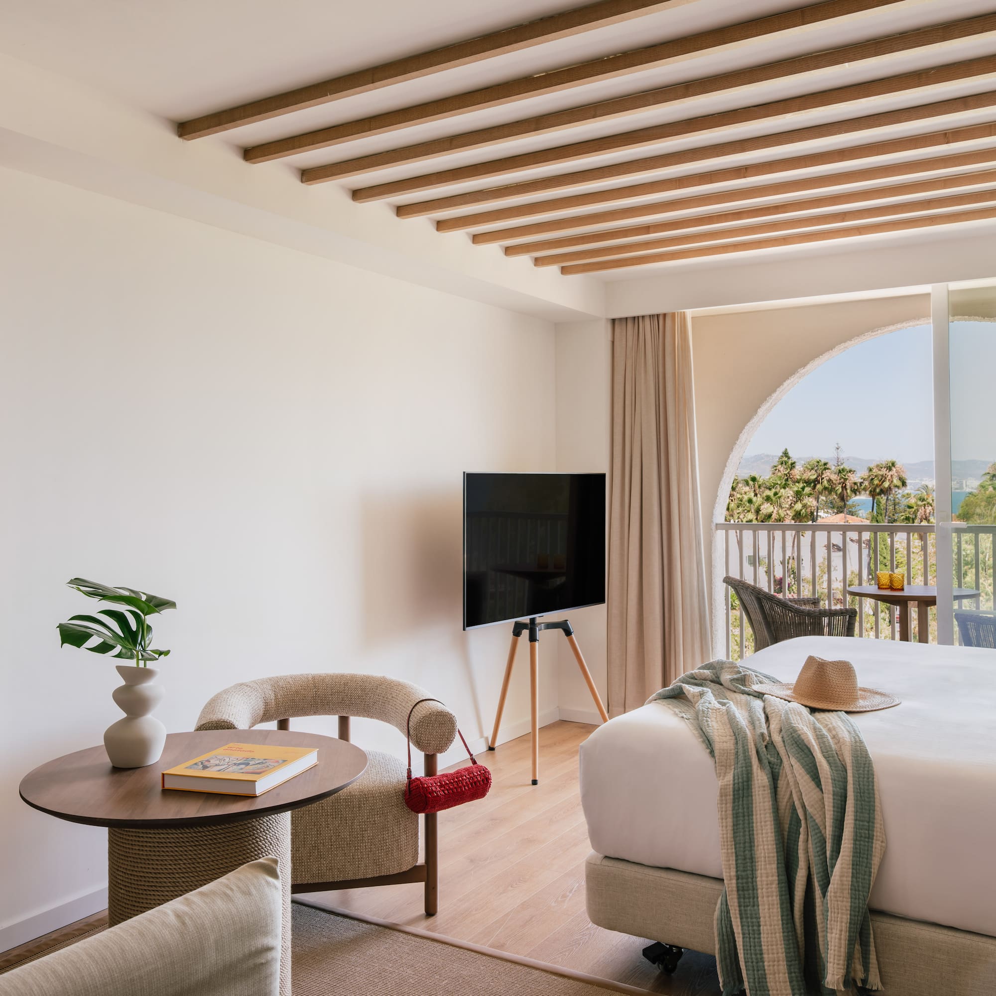 a room with a bed and a television