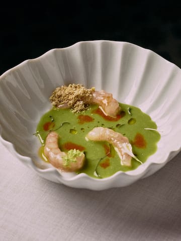a bowl of green soup with shrimp
