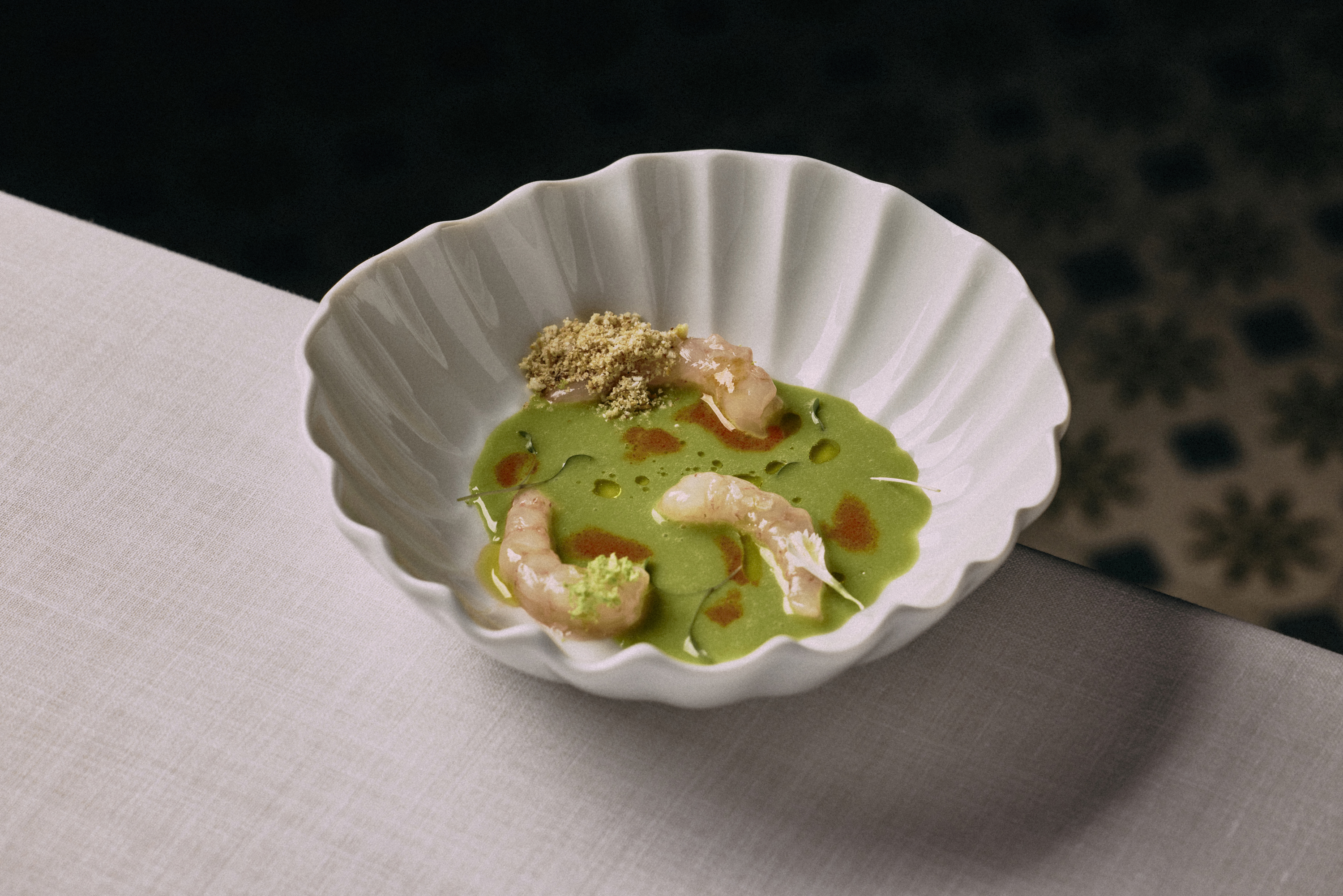 a bowl of green soup with shrimp