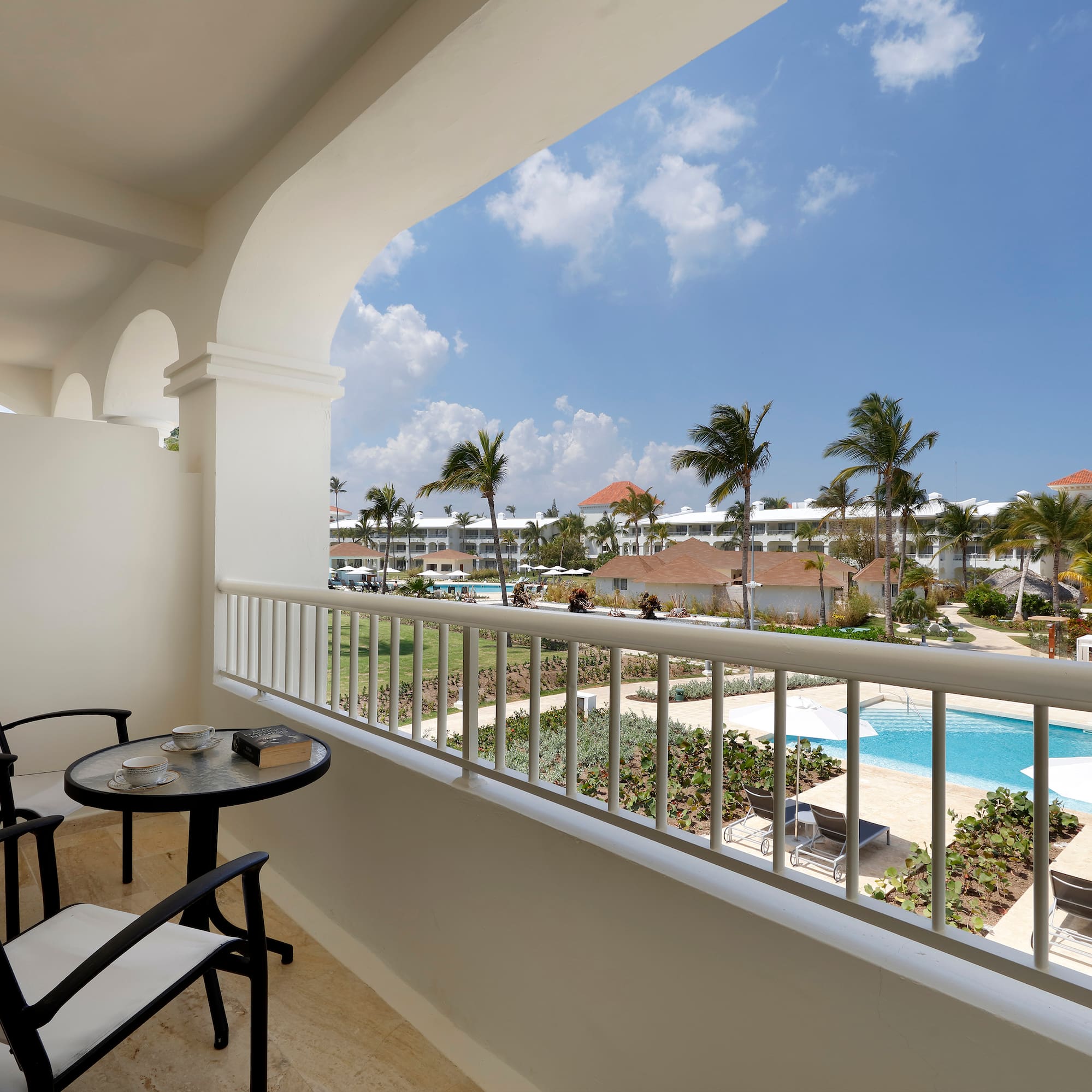 a balcony with a table and chairs