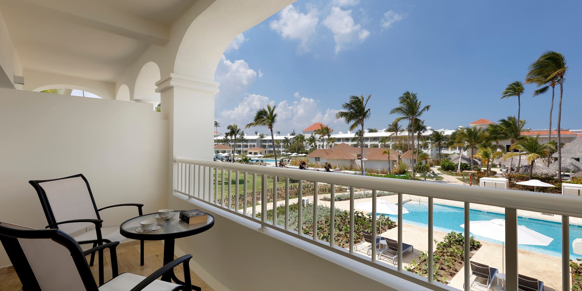 a balcony with a table and chairs