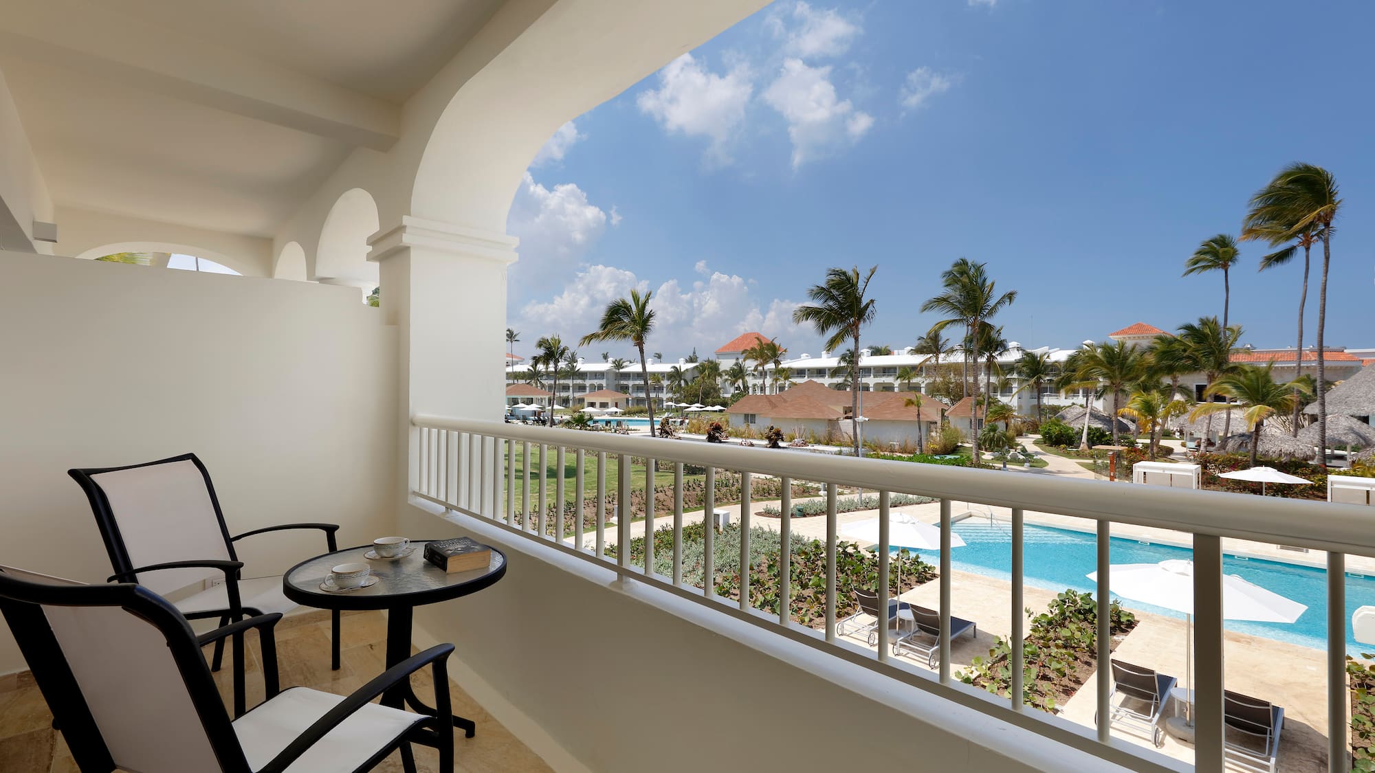 a balcony with a table and chairs