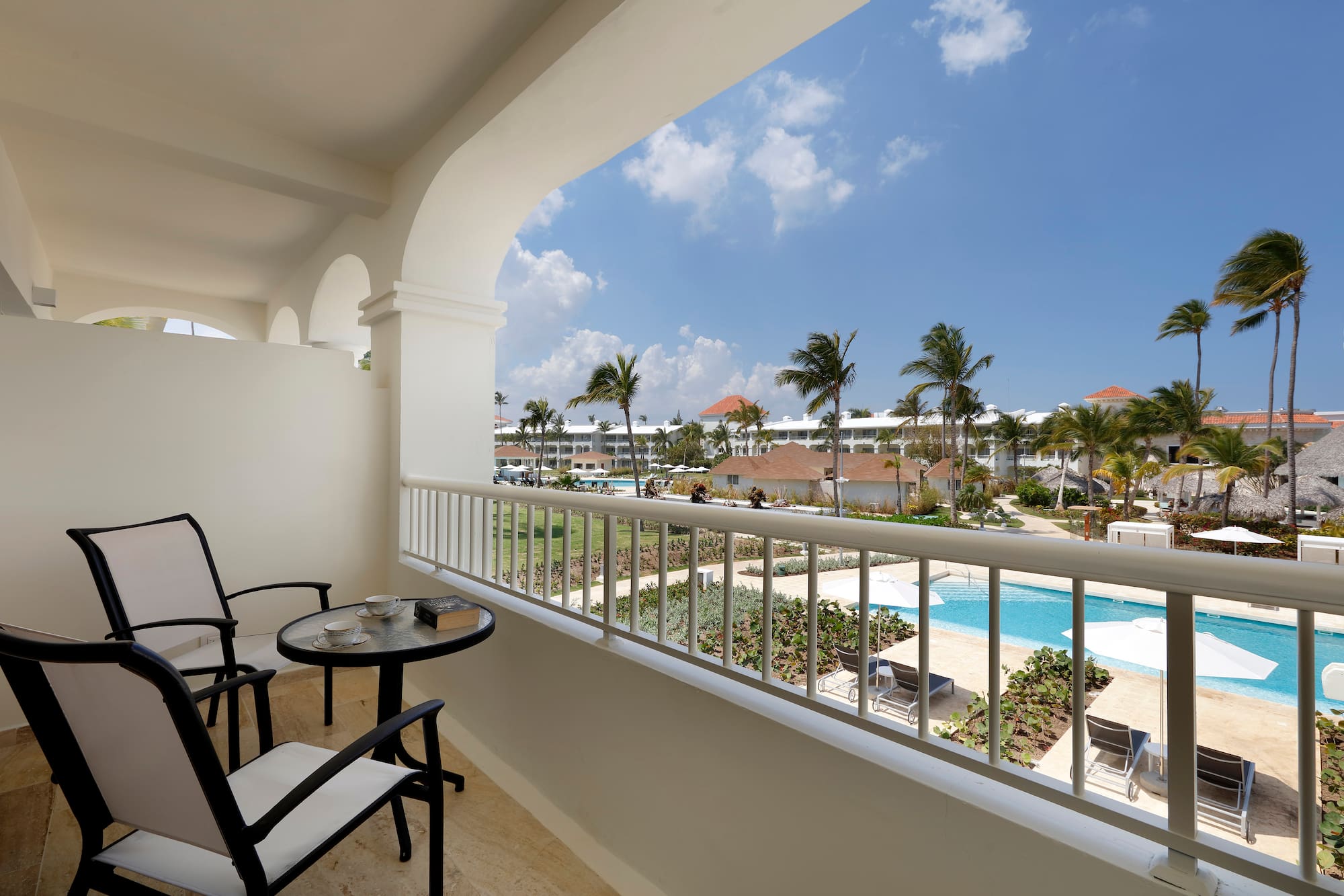 a balcony with a table and chairs