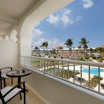 a balcony with a table and chairs