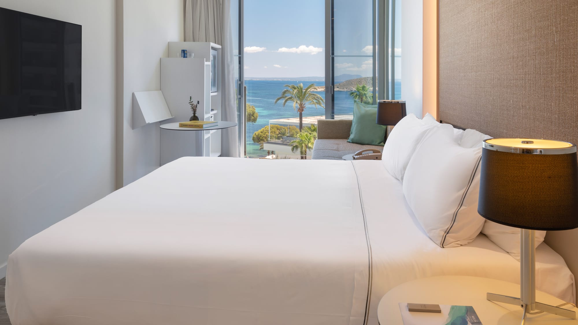 a bed with a view of the ocean