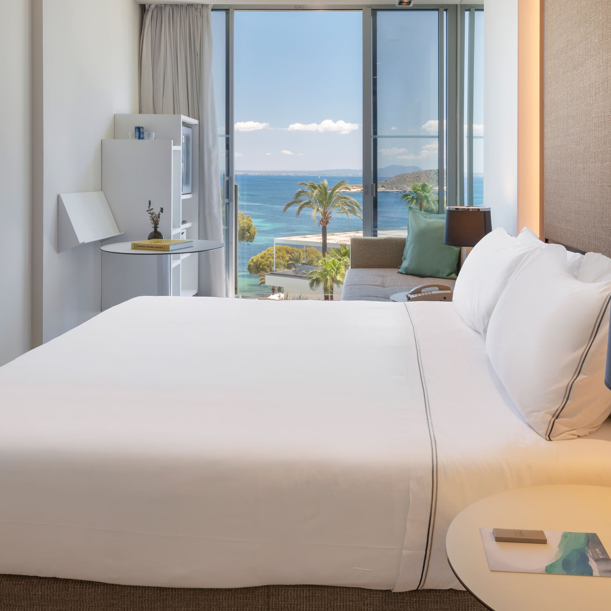 a bed with a view of the ocean