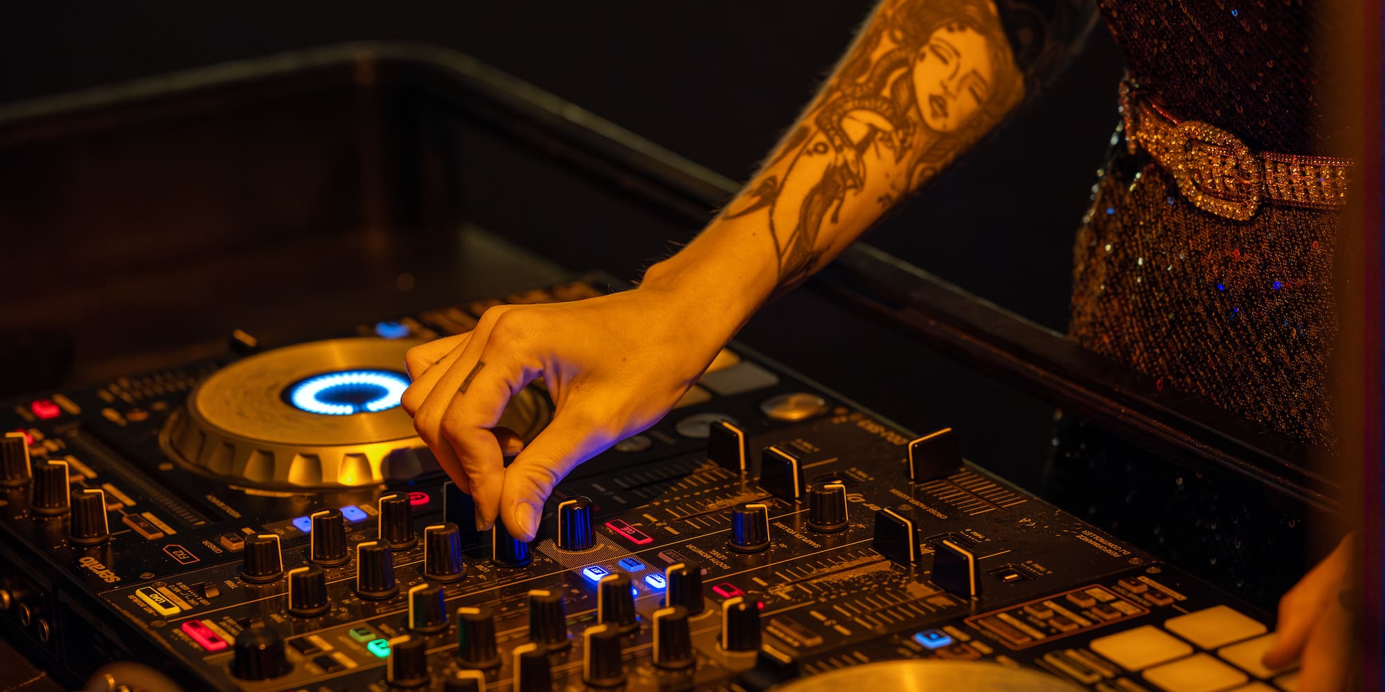 a person playing music on a mixer