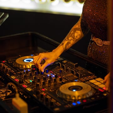 a person playing music on a mixer