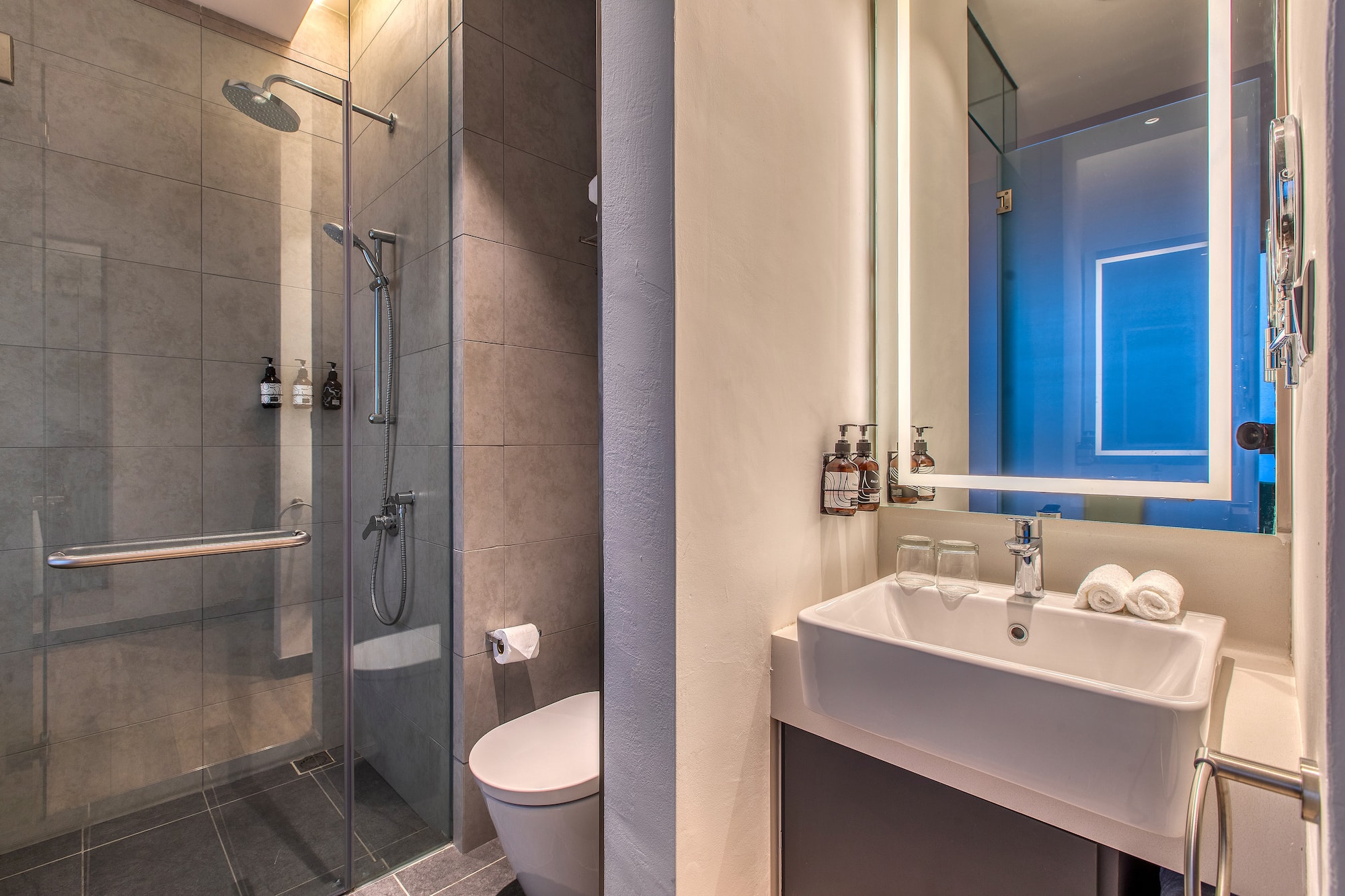 a bathroom with a shower and sink