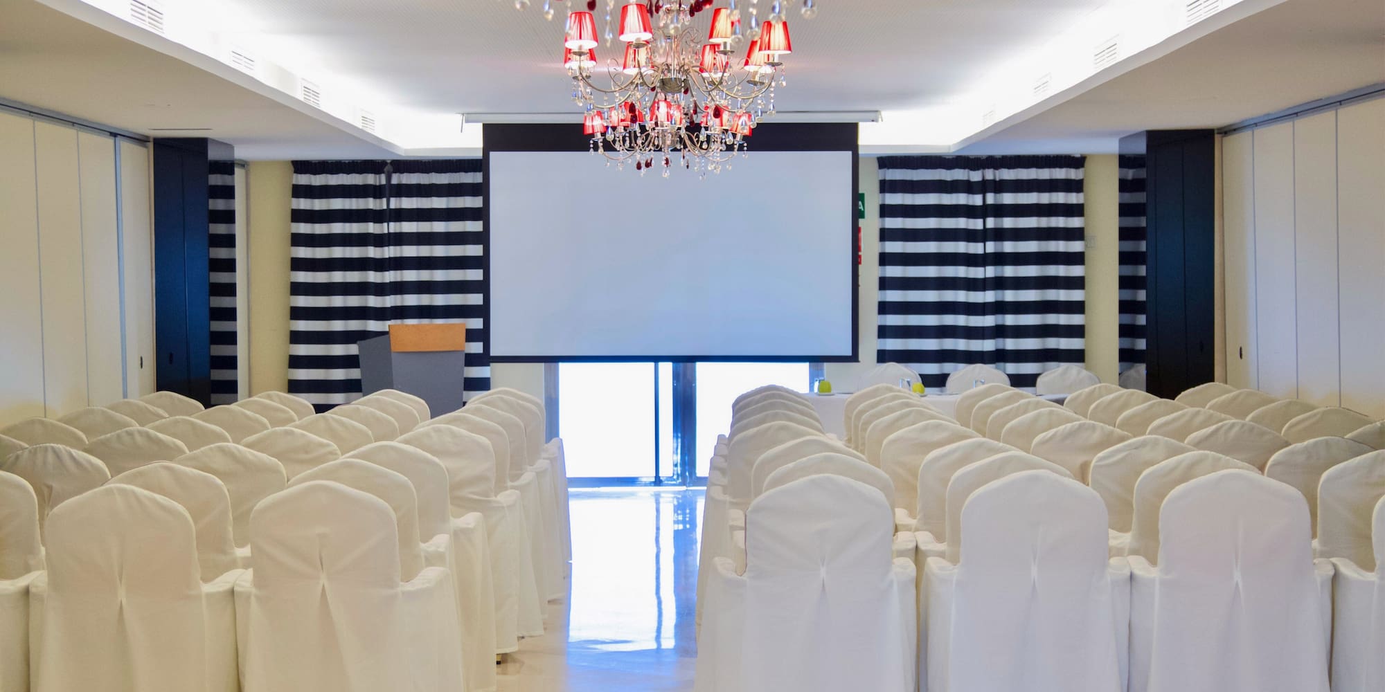a room with chairs and chandelier